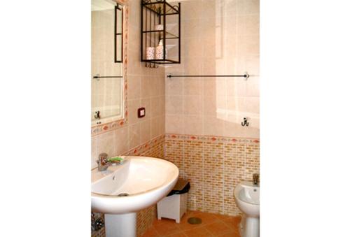 a bathroom with a sink and a toilet at B&B Domus Gemi in Naples