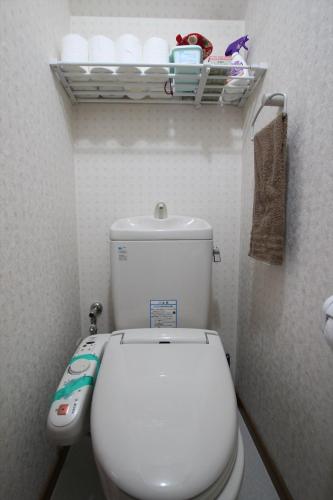 a small bathroom with a white toilet in a room at Nagomiya Kyoto Minami-Enmachi in Kyoto
