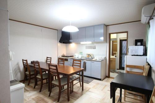 a kitchen and dining room with a table and chairs at Nagomiya Kyoto Minami-Enmachi in Kyoto