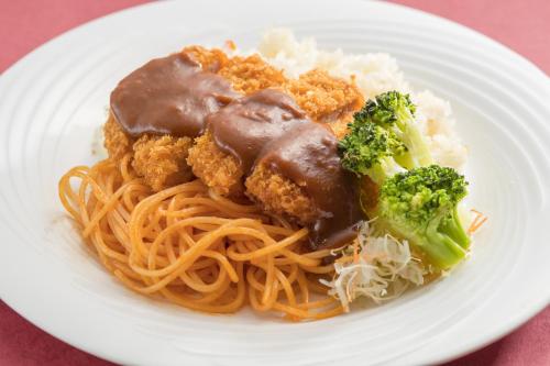 a white plate of food with spaghetti and broccoli at Hotel Forza Nagasaki in Nagasaki