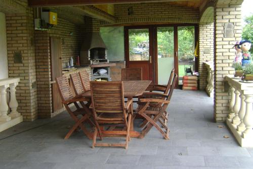 a wooden table and chairs on a patio at Le Castillon in Trivières