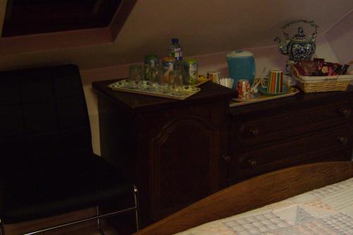 a bedroom with a dresser with alcohol bottles on it at Le Castillon in Trivières