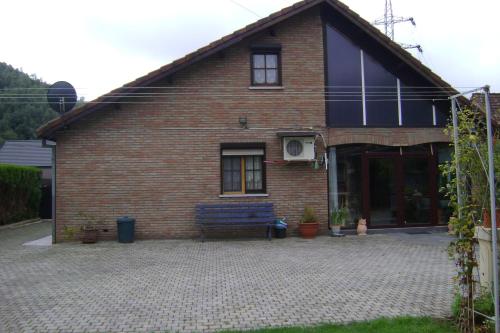a brick house with a bench in front of it at Le Castillon in Trivières