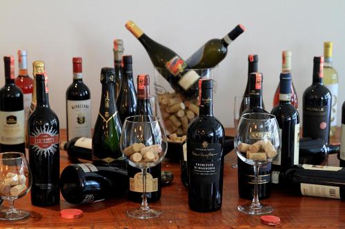a group of wine bottles and wine glasses on a table at Best Western Premier Ark Hotel in Tirana