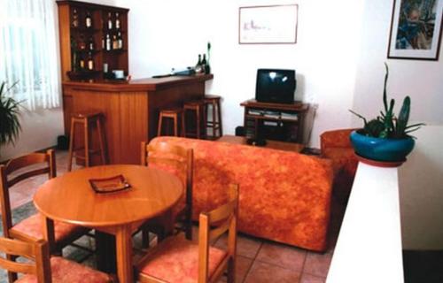 a living room with a couch and a table at Ionion Hotel in Syvota