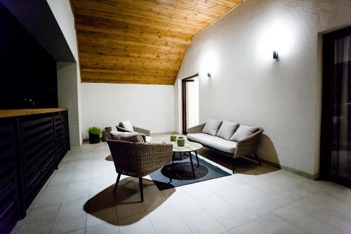 a living room with a couch and chairs and a table at Bulwary Biznes in Mielec