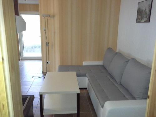 a living room with a couch and a table at Strandidyll 9 in Ueckeritz