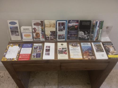 a display of books on a wooden table at Auberge Daniella in Franschhoek