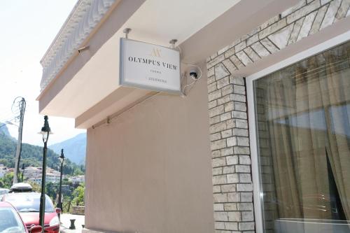 a sign on the side of a building at Olympus View Rooms Sauna & Spa in Litochoro