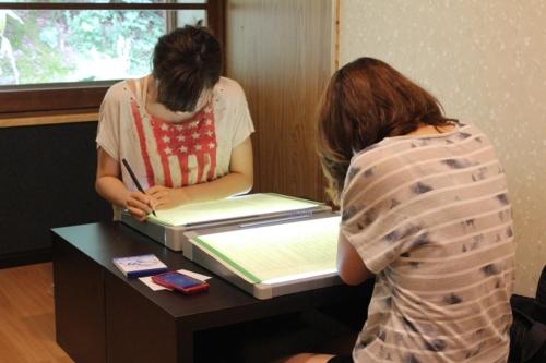 two women are standing at a table with at Shukubo Kansho-in Temple Sanrakuso in Daisen