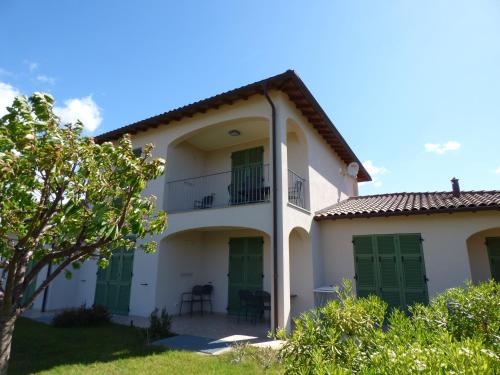 a large white house with green doors at Antico Principato di Seborga in Vallebona