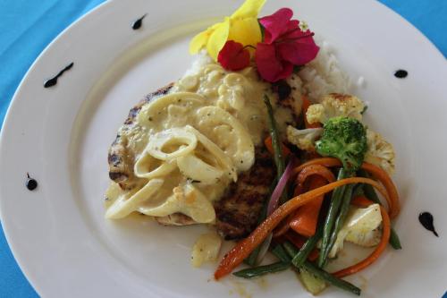 a plate of food with rice and vegetables on it at Seis Playas Hotel in Tamarindo