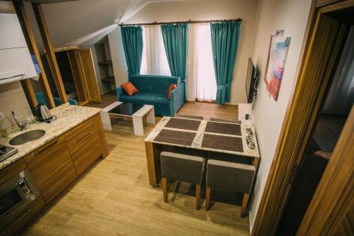 a small kitchen with a table and a blue couch at Turkuaz Apart in Uzungöl