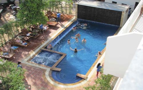 an overhead view of people in a swimming pool at Blossoming Romduol Boutique in Siem Reap