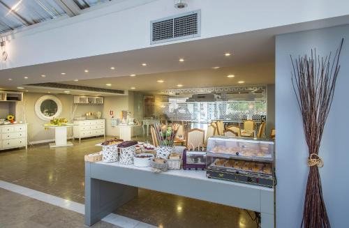 a store with a counter with some pastries at Airotel Parthenon in Athens