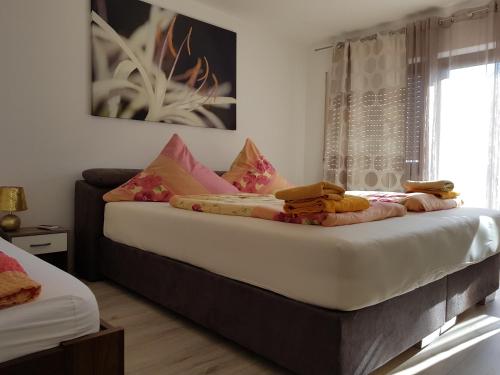 a bedroom with a bed with pillows and a window at Hotel Rosenbach in Reutlingen