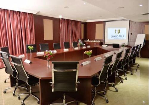 a large conference room with a long table and chairs at Grand Pela Hotel & Suites in Abuja