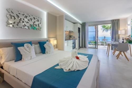 a bedroom with a large bed with blue and white at Klayman Diamond Aparthotel in Acantilado de los Gigantes
