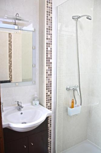 a bathroom with a sink and a shower at Casa Azul Altamira in Viana do Castelo