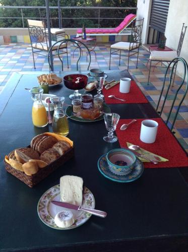 a table with bread and other foods on it at Villa Mirabel in Île du Levant