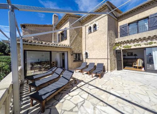 a group of lounge chairs sitting on a patio at Domaine du Bois d'Amont in Cabris