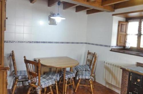 a kitchen with a table and chairs in a room at El Cantil in Sevares