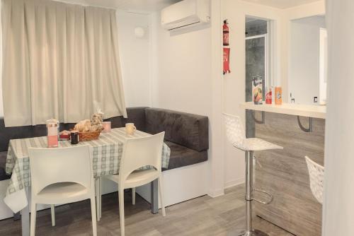 a living room with a table and chairs and a couch at Camping Barco Reale in Lamporecchio