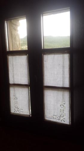 two windows in a room with a view of a field at Valbuona b&b in Mercatello sul Metauro