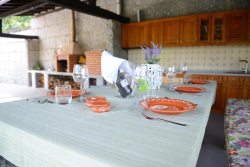 a white table with plates and glasses on it at AboimHouse in Amarante