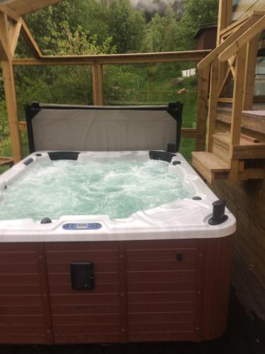a hot tub in the middle of a deck at Jølster Holiday home in Skei 