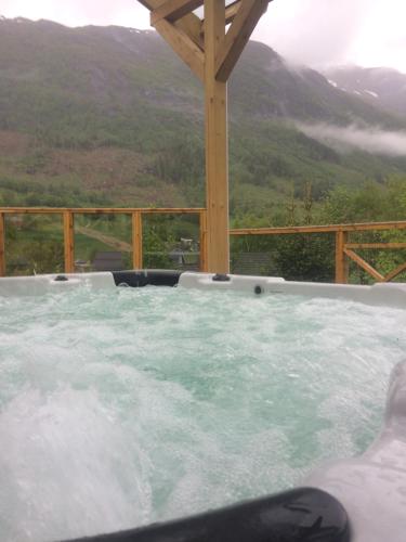 a hot tub with a view of a mountain at Jølster Holiday home in Skei 
