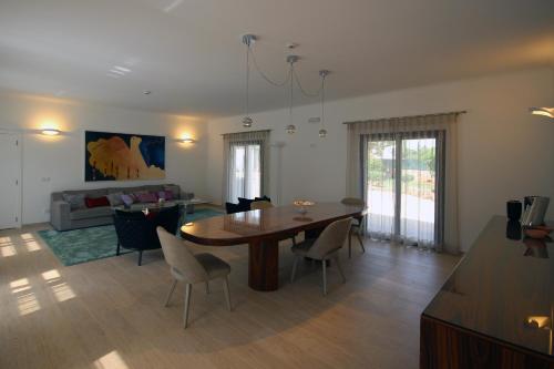 a living room with a wooden table and chairs at L&F House in Algoz