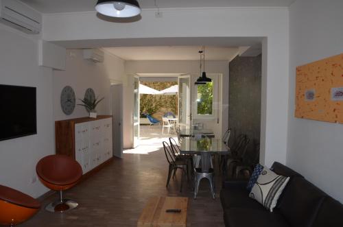 a living room with a couch and a table at Dimora 16 Rooms & Garden in Prato