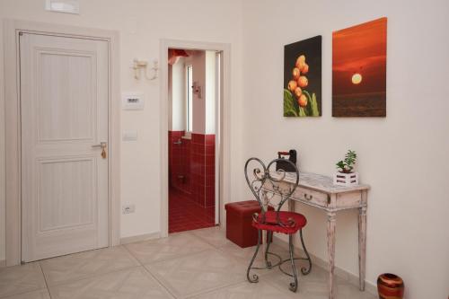 a room with a table and a chair and a door at Merydamy in Mattinata