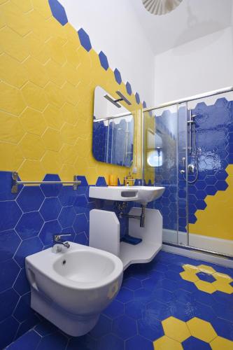 a bathroom with a sink and a toilet in it at Merydamy in Mattinata
