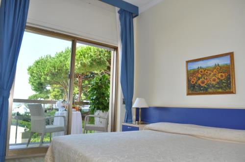 Postel nebo postele na pokoji v ubytování Hotel La Playa