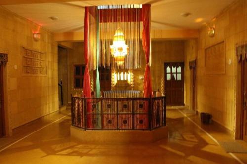 a lobby with a chandelier in a building at Tripli Hotels Prithvi Palace in Jaisalmer