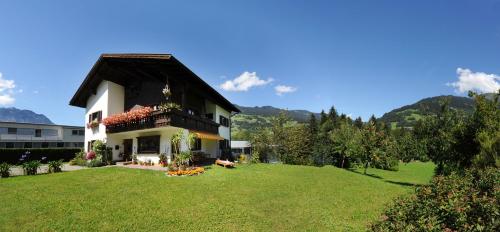 a house with a green lawn in front of it at Ferienwohnung Bitschnau in Schruns-Tschagguns