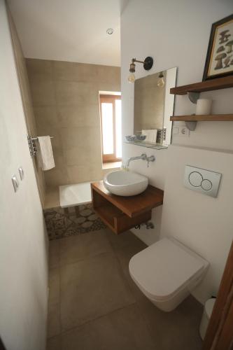 a bathroom with a white toilet and a sink at Casa Rural Miller's of Frigiliana in Frigiliana