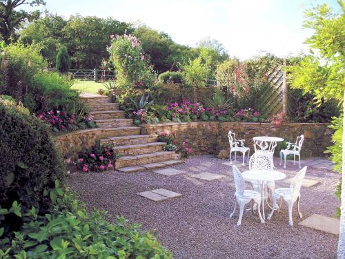 a garden with a table and chairs and stairs at Fernside Bed and Breakfast in Templeton