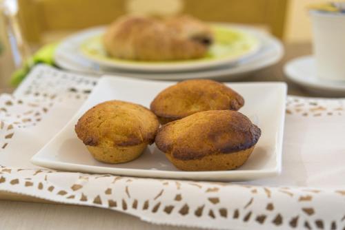 three muffins on a plate on a table at Notos b&b in Otranto