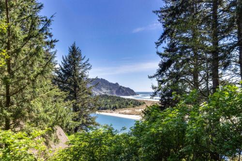 a view of a lake through the trees at Cascade Head Salmon River Getaway in Three Rocks