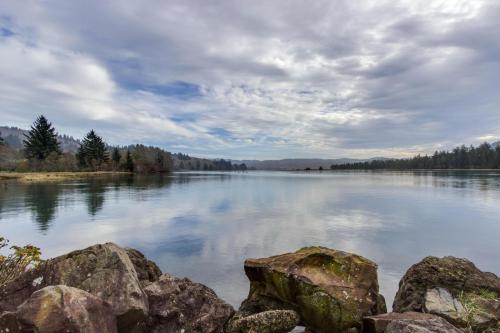 a view of a lake with rocks in the water at Cascade Head Salmon River Getaway in Three Rocks