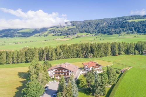 an aerial view of a house in a green field at Apartments Hubertushof in Dobbiaco