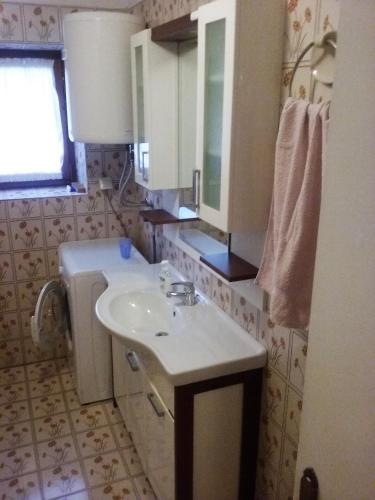 a bathroom with a sink and a mirror at Apartment Villa Venezia in Perast