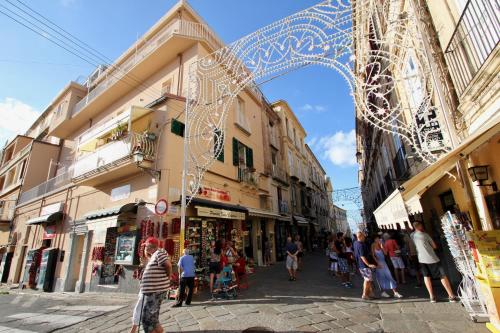 a group of people walking down a street with an arch at Townhouse Tropea in Tropea