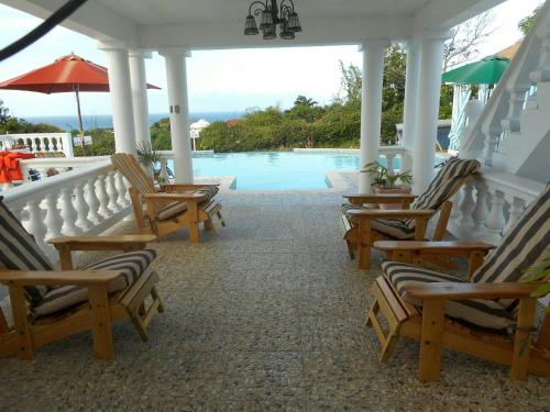 a group of chairs sitting next to a swimming pool at Royal Vista Villa in Duncans
