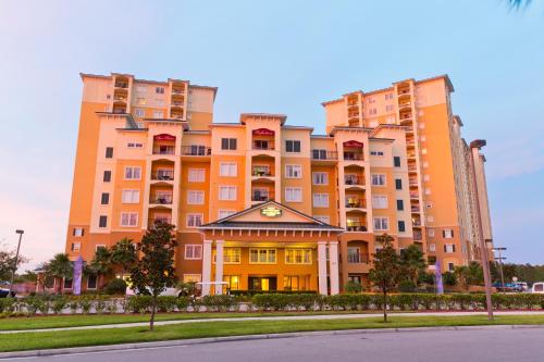 a large apartment building in front of a street at Lake Buena Vista Resort Village and Spa, Near Disney in Orlando