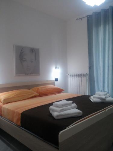 a bedroom with a bed with towels on it at Residenza Azzurra in Tropea