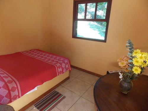 Ένα ή περισσότερα κρεβάτια σε δωμάτιο στο Pousada Jacu Acu